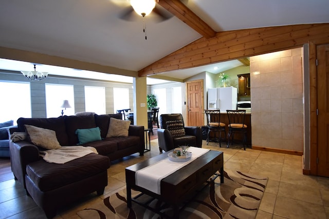 tiled living room featuring a healthy amount of sunlight, wooden walls, lofted ceiling with beams, and ceiling fan with notable chandelier