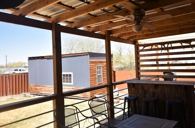 wooden deck with ceiling fan and an outdoor bar