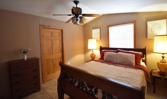 tiled bedroom featuring ceiling fan and lofted ceiling