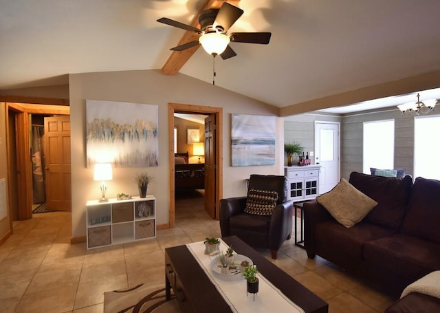 living room featuring lofted ceiling with beams, light tile patterned floors, and ceiling fan with notable chandelier