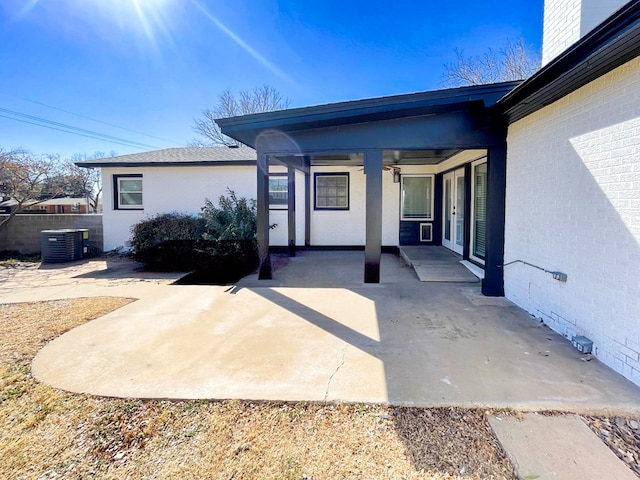 entrance to property featuring central AC, french doors, a patio area, and fence