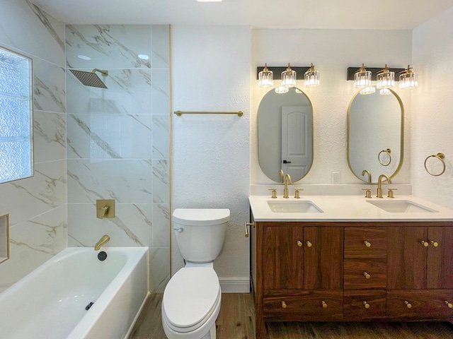 bathroom featuring a sink, toilet, and double vanity