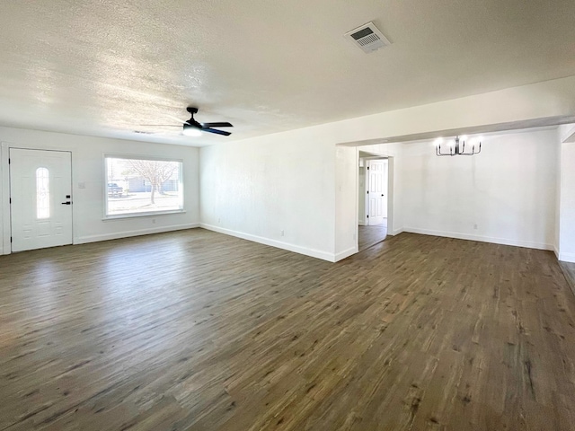 unfurnished living room featuring a textured ceiling, visible vents, dark wood-style flooring, and ceiling fan with notable chandelier