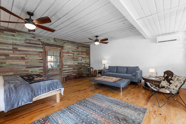 bedroom with ceiling fan, wood walls, wood-type flooring, and a wall mounted AC