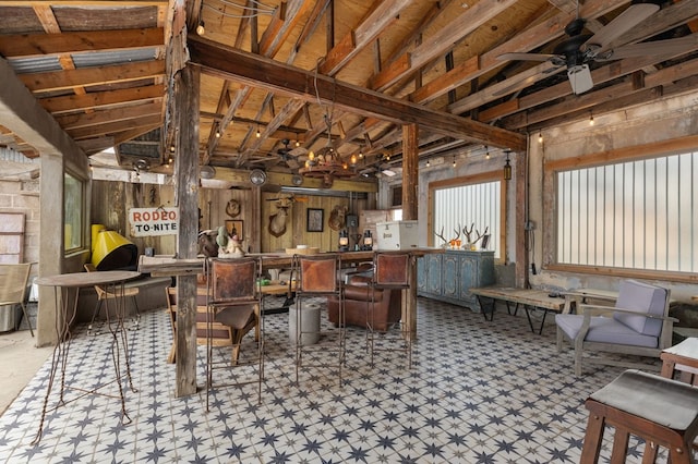 dining area featuring ceiling fan and lofted ceiling