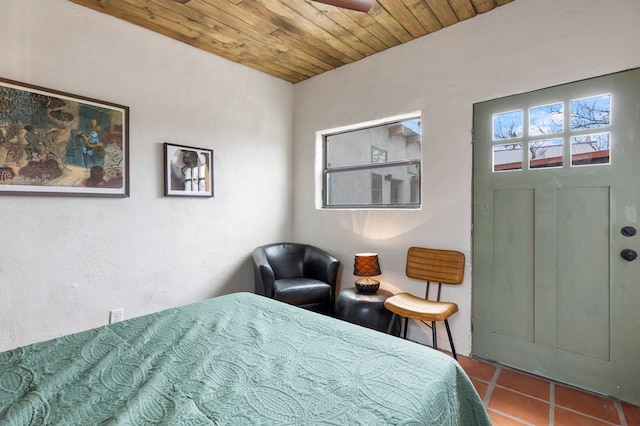 bedroom with light tile patterned floors and wooden ceiling