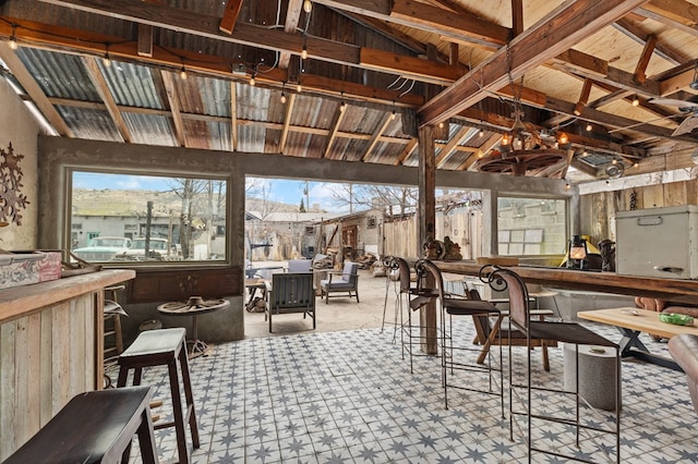 interior space featuring plenty of natural light and lofted ceiling with beams