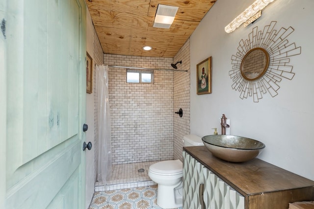 bathroom featuring tile patterned floors, curtained shower, vanity, and toilet