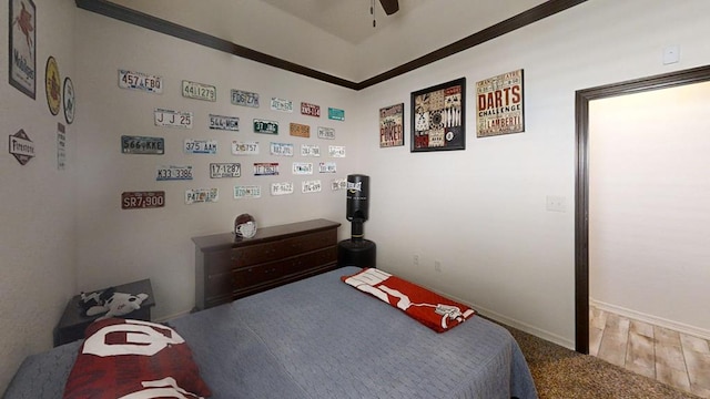 bedroom featuring ceiling fan, wood-type flooring, and crown molding