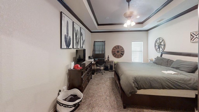 carpeted bedroom with ceiling fan, a raised ceiling, and ornamental molding