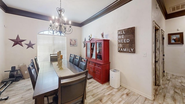 dining room featuring a chandelier, light hardwood / wood-style floors, and crown molding