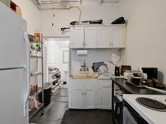 kitchen featuring white cabinets and white appliances