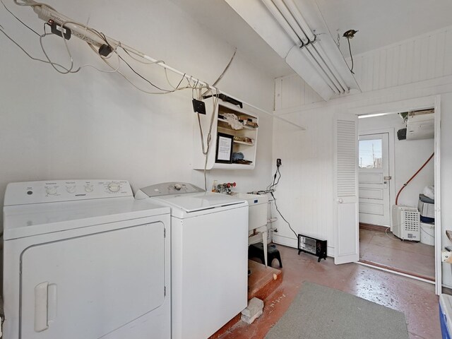 clothes washing area with separate washer and dryer