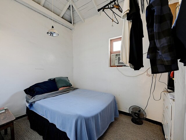 carpeted bedroom featuring lofted ceiling with beams, cooling unit, and wood ceiling