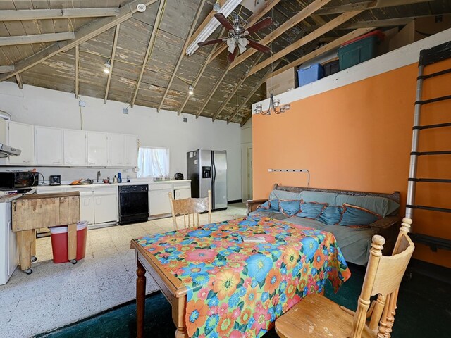 interior space featuring beam ceiling, stainless steel fridge, and high vaulted ceiling