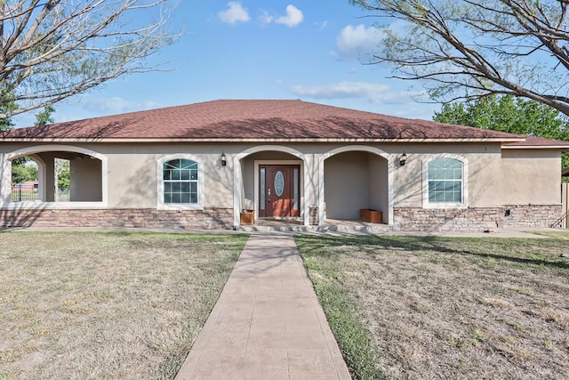 mediterranean / spanish home with a front lawn