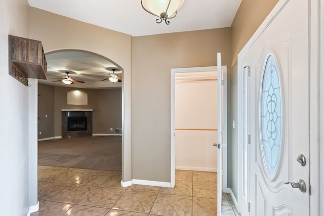 entrance foyer featuring light tile patterned floors and ceiling fan