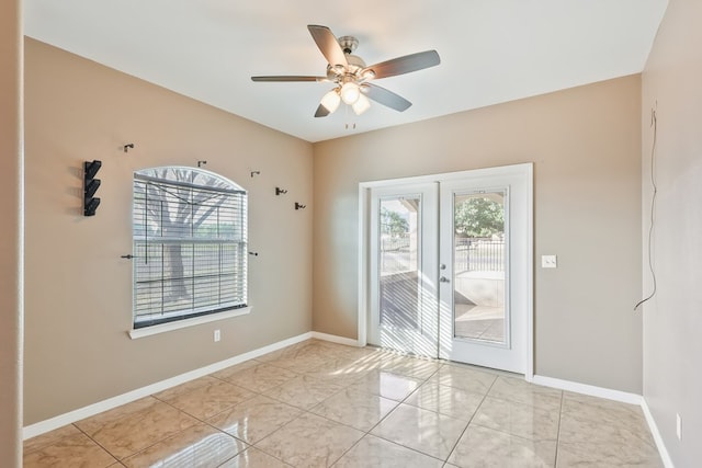 empty room with ceiling fan and french doors