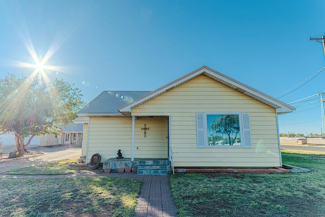 rear view of property with a lawn