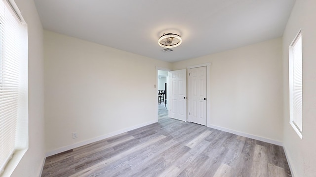 empty room featuring plenty of natural light and light wood-type flooring