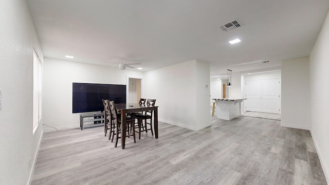 dining room featuring light hardwood / wood-style flooring and ceiling fan