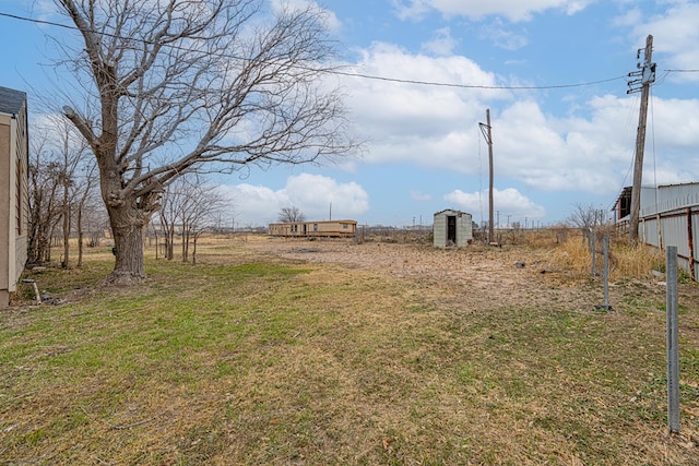 view of yard featuring a shed and a rural view