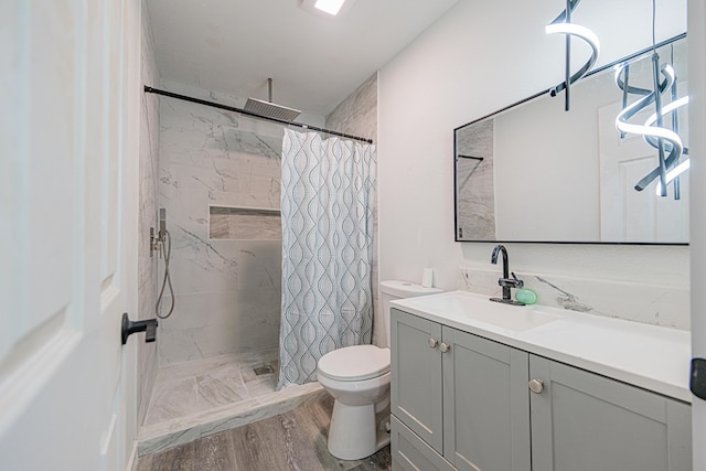 bathroom with vanity, toilet, curtained shower, and hardwood / wood-style floors