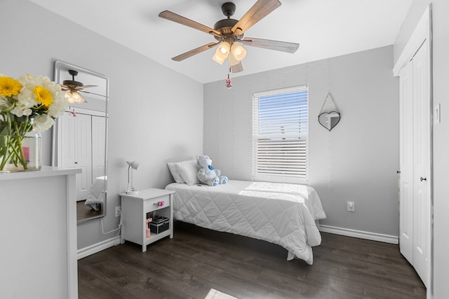 bedroom with a closet, dark hardwood / wood-style floors, and ceiling fan