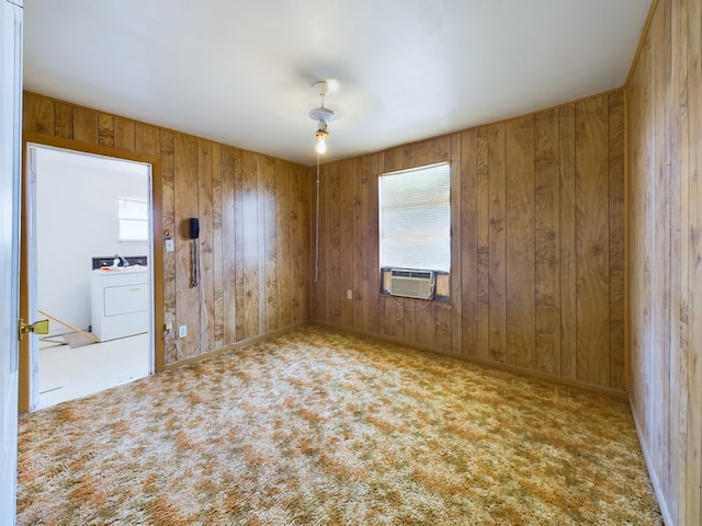 spare room with cooling unit, washer / dryer, light carpet, and a wealth of natural light