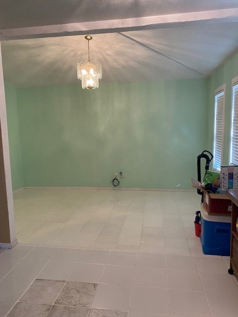 interior space featuring vaulted ceiling and a chandelier