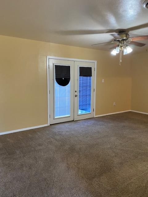 carpeted spare room with french doors and ceiling fan