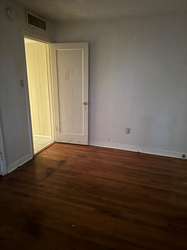 empty room featuring dark wood-type flooring