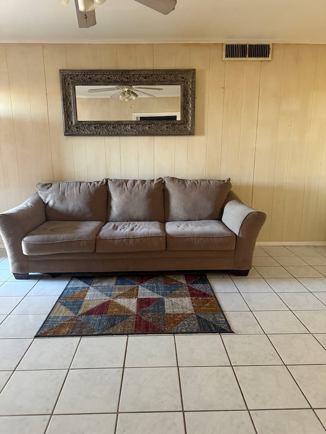 tiled living room featuring wooden walls