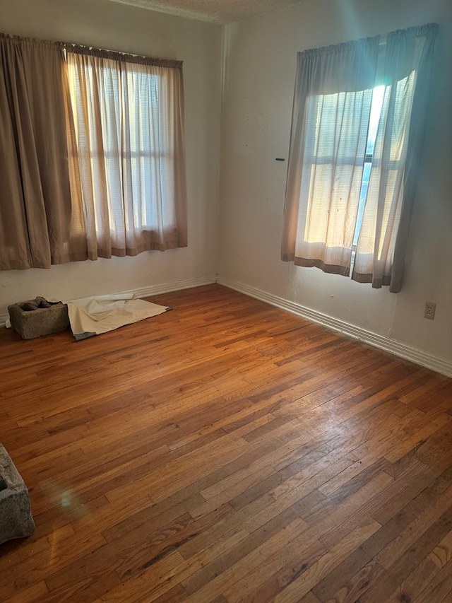 unfurnished room with dark wood-type flooring