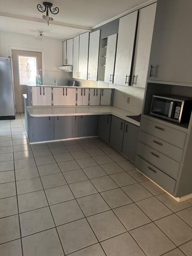 kitchen with ceiling fan, gray cabinets, light tile patterned floors, appliances with stainless steel finishes, and kitchen peninsula