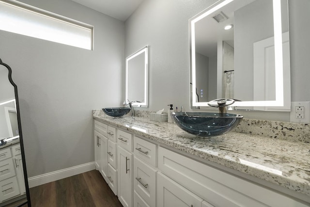 bathroom featuring vanity and wood-type flooring