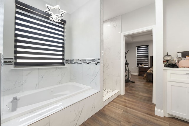 bathroom with vanity, hardwood / wood-style flooring, and independent shower and bath