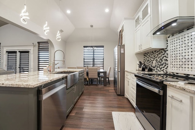 kitchen featuring white cabinets, wall chimney exhaust hood, lofted ceiling, and stainless steel appliances