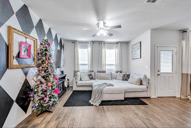 living room with hardwood / wood-style flooring and ceiling fan