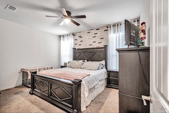 carpeted bedroom featuring ceiling fan and brick wall