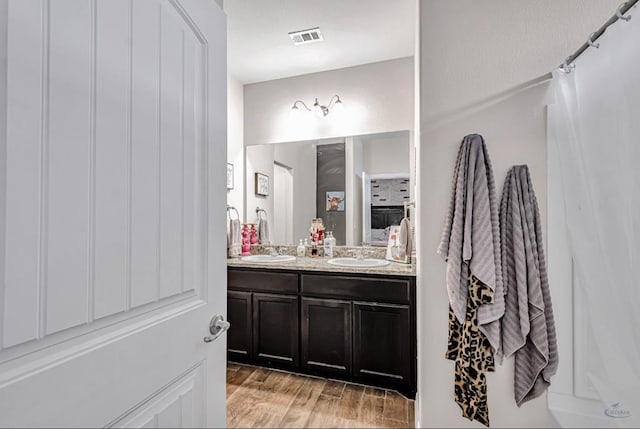 bathroom featuring hardwood / wood-style flooring and vanity