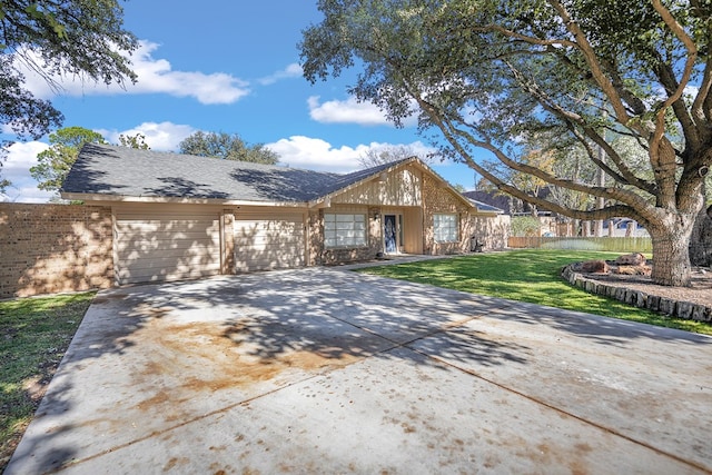 ranch-style home featuring a garage and a front yard