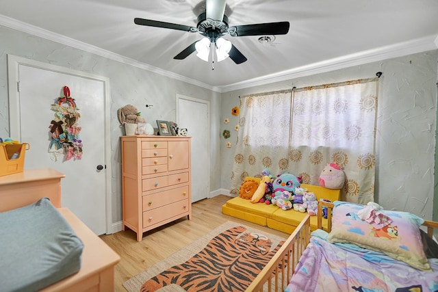 bedroom featuring ceiling fan, light hardwood / wood-style floors, and ornamental molding