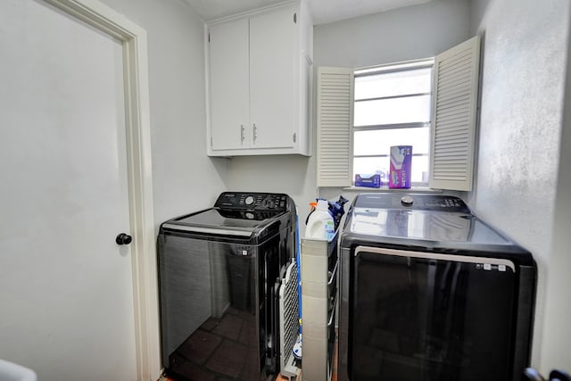 clothes washing area with cabinets and independent washer and dryer