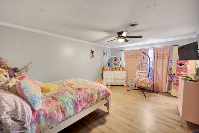 bedroom featuring hardwood / wood-style flooring, ceiling fan, and ornamental molding