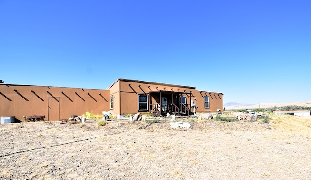 back of property featuring a mountain view