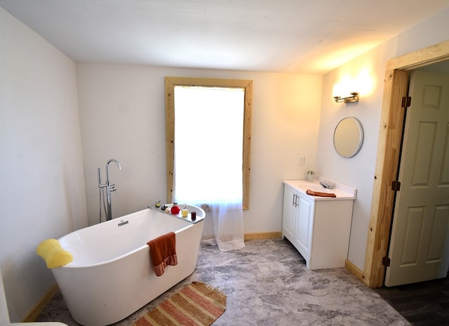 bathroom with a bathing tub and vanity