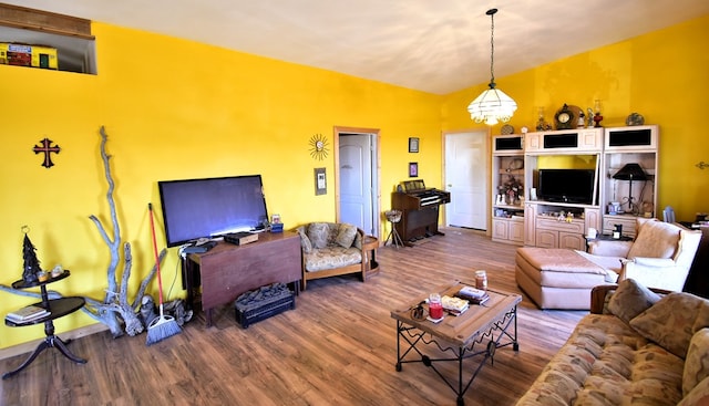 living room with hardwood / wood-style flooring and an inviting chandelier