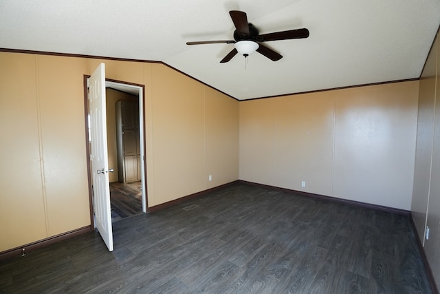 spare room featuring vaulted ceiling, crown molding, ceiling fan, and dark hardwood / wood-style flooring