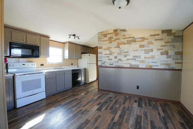 kitchen with vaulted ceiling, sink, black appliances, dark wood-type flooring, and a textured ceiling